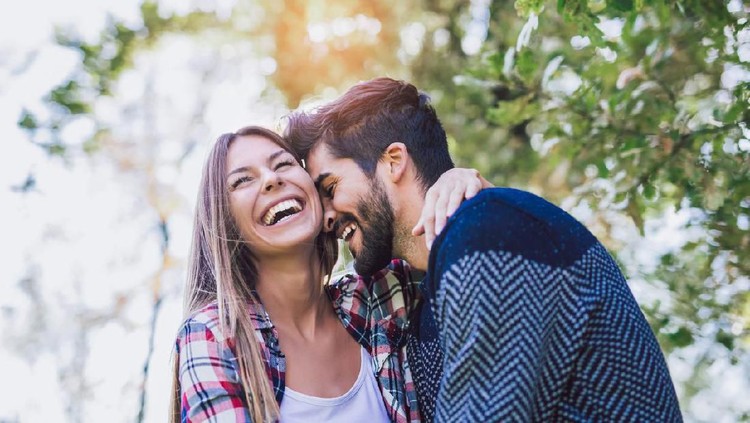 Loving husband comfort upset offended wife, caressing and hugging her from behind, caring man make peace and reconcile with lover, show support, couple in fight overcome family problems together