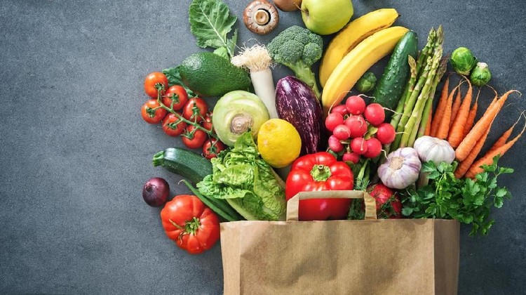 1128687123 Healthy food selection. Shopping bag full of fresh vegetables and fruits. Flat lay food on table