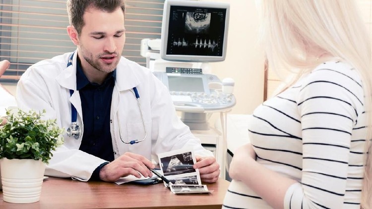 Doctor showing baby ultrasound image to pregnant woman. showing ultrasound usg pregnancy gynecologist patient pregnant concept