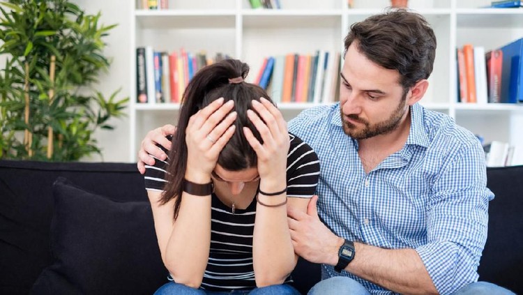 One loving boyfriend trying to comfort girlfriend embracing her