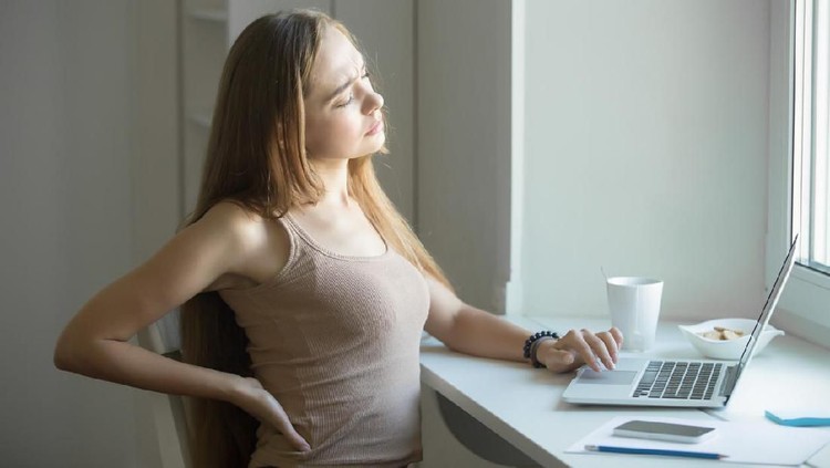 Woman suffering from back ache on the bed, healthcare and problem concept