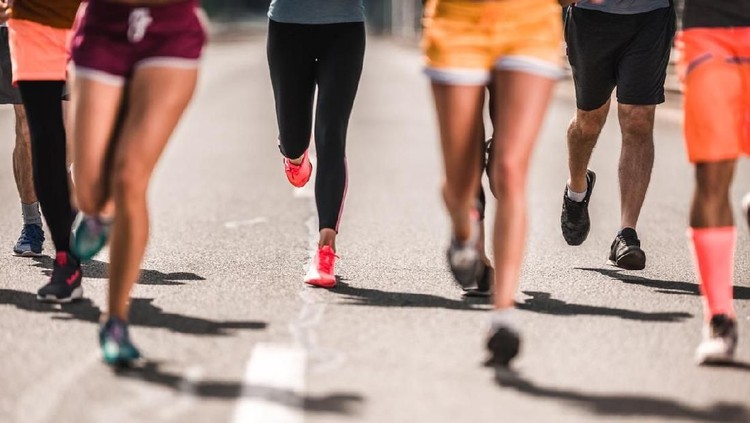Unrecognizable athletic people running a marathon on the road&period;