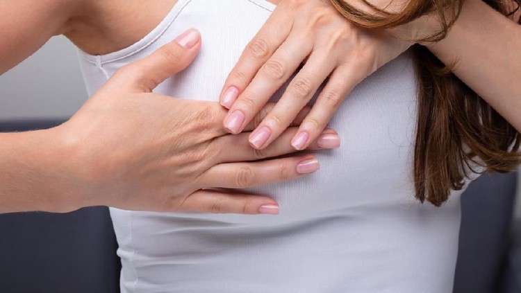 Close-up Of A Woman's Hand On Breast Suffering From Pain
