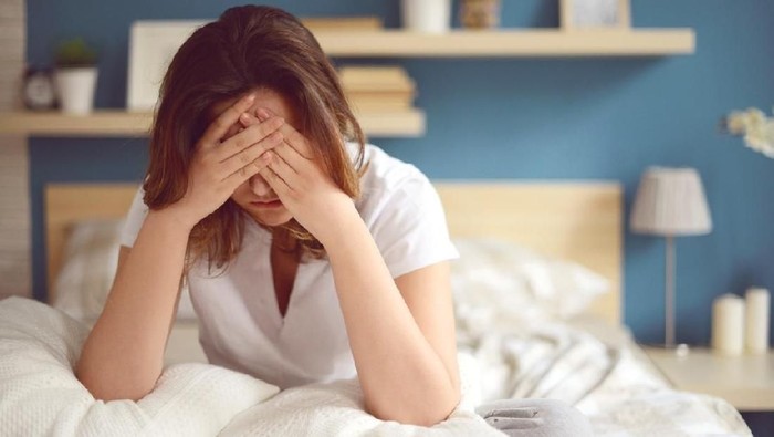Unhappy girl in a bedroom