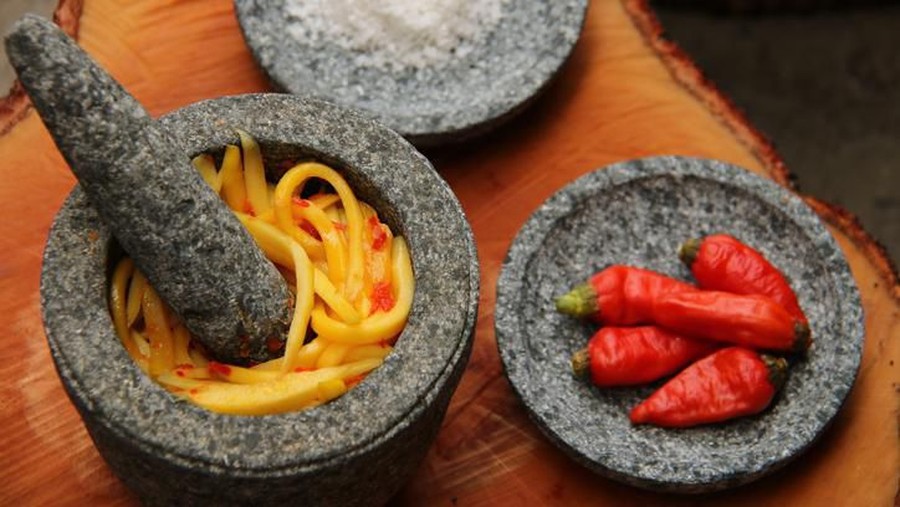 sambal mangga A popular Indonesian condiment of red chili peppers and tomato paste in traditional mortar and pestle is sambal ulek