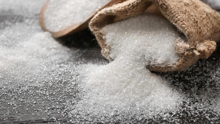 Sack with pure sugar on table