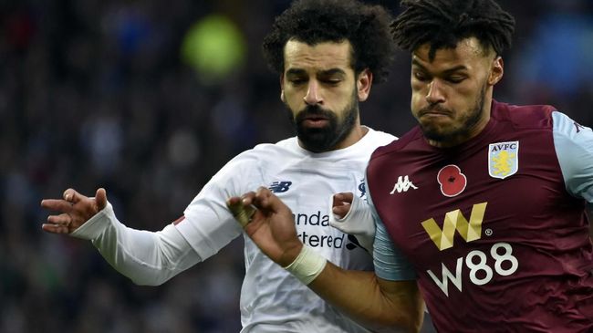 Liverpool's Mohamed Salah, left, duels for the ball with Aston Villa's Tyrone Mings during the English Premier League soccer match between Aston Villa and Liverpool at Villa Park in Birmingham, England, Saturday, Nov. 2, 2019. (AP Photo/Rui Vieira)