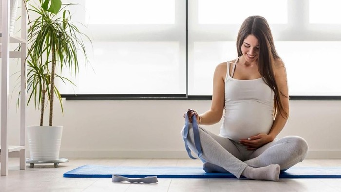Portrait of happy smiling beautiful pregnant woman at home. Mother-to-be