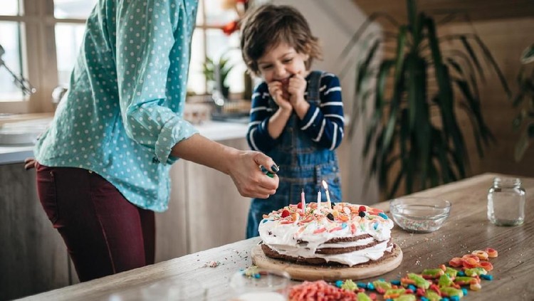 Young boy enjoying his birthday cake