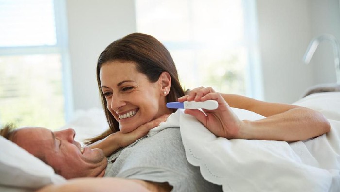 Shot of a mature couple feeling excited after taking a home pregnancy test