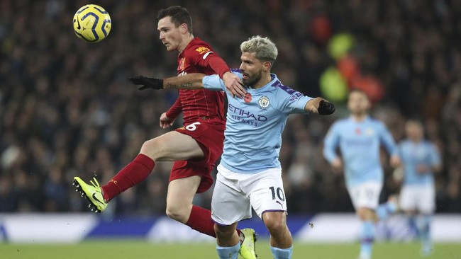 Liverpool's Dejan Lovren, left, challenges for the ball with Manchester City's Sergio Aguero during the English Premier League soccer match between Liverpool and Manchester City at Anfield stadium in Liverpool, England, Sunday, Nov. 10, 2019. (AP Photo/Jon Super)