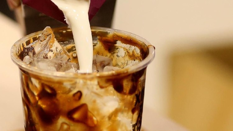 gula aren brown sugar A closer look on milk pour on a cup of boba (tapioca pearl bubble) cooked with brown sugar and added with ice cubes.