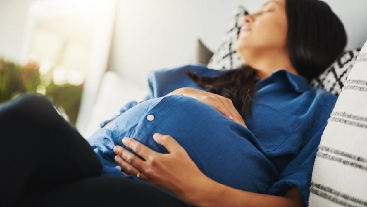 Shot of a pregnant woman sleeping on a bed at home