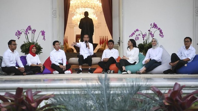Presiden Joko Widodo (keempat kiri) bersama staf khusus yang baru dari kalangan milenial (kiri ke kanan) CEO Amartha, Andi Taufan Garuda Putra, Perumus Gerakan Sabang Merauke Ayu Kartika Dewi, Pendiri Ruang Guru Adamas Belva Syah Devara, Peraih beasiswa kuliah di Oxford Billy Gracia Yosaphat Mambrasar, CEO dan Founder Creativepreneur Putri Indahsari Tanjung, Pendiri Thisable Enterprise Angkie Yudistia dan Mantan Ketua Pergerakan Mahasiswa Islam Indonesia/PMII Aminuddin Ma'ruf ketika diperkenalkan di halaman tengah Istana Merdeka Jakarta, Kamis (21/11/2019). Ketujuh stafsus milenial tersebut mendapat tugas untuk memberi gagasan serta mengembangkan inovasi-inovasi di berbagai bidang. ANTARA FOTO/Wahyu Putro A/nz