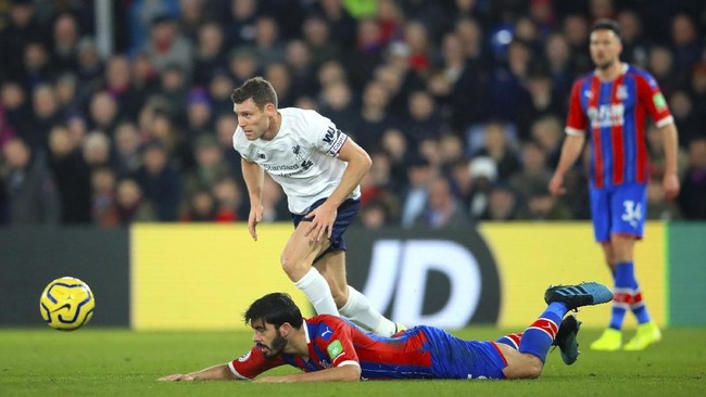 Liverpool's James Milner and Crystal Palace's James Tomkins battle for the ball  during the English Premier League soccer match between Crystal Palace and Liverpool, at Selhurst Park, London, Saturday, Nov. 23, 2019. (Adam Davy/PA via AP)