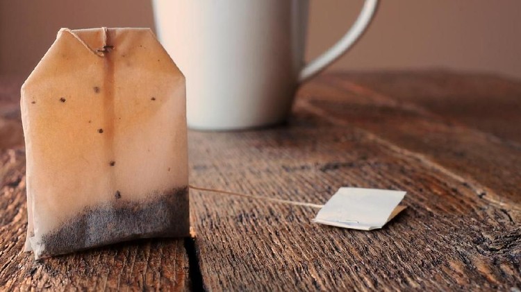 Beautiful girl with tea bags on eyes. Top view.