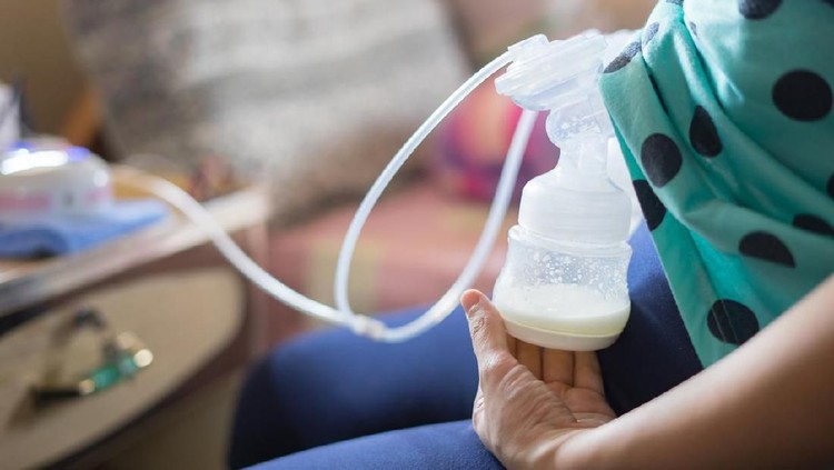955881900 Automatic breast pump, mothers breasts milk is the most healthy food for newborn baby. Happy mother with babys at bed room ,home,vintage color