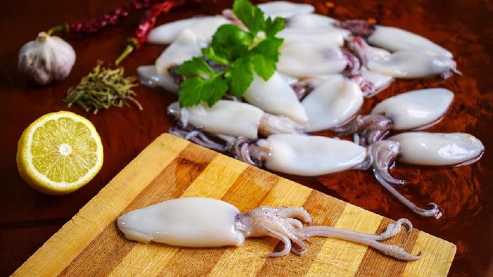 Fresh calamari. Squid. Seafood, lemon, garlic, pepper, parsley.
