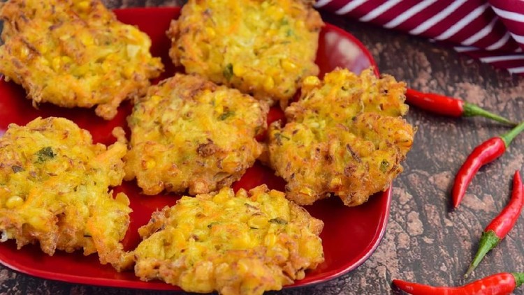 Indonesian corn fritters or Bakwan Jagung served with red chilies