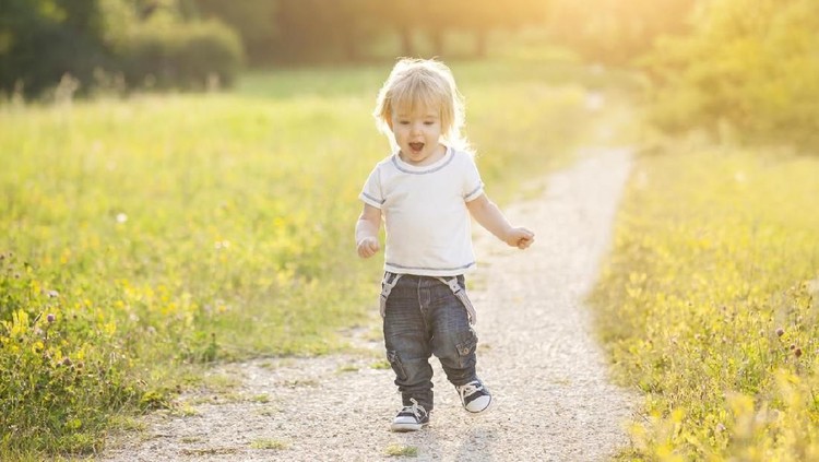 Two happy children playing European football outdoors in school yard. Kids play soccer. Active sport for preschool child. Ball game for young kid team. Boy and girl score a goal in football match.