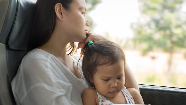 Mother holding little boy and crying, family violence