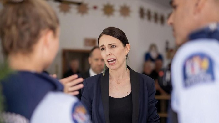 New Zealand's Prime Minister Jacinda Ardern, center, talks first responders in Whakatane, New Zealand, Tuesday, Dec. 10, 2019. A volcanic island in New Zealand erupted Monday Dec. 9 in a tower of ash and steam while dozens of tourists were exploring the moon-like surface, killing multiple people and leaving many more missing.(Dom Thomas/Pool Photo via AP)