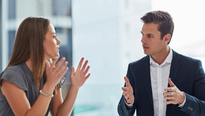 Aged and young women sitting staring at each other with distrust and animosity, focus on millennial girl. Different ages various generations employees conflict fight for company position or leadership