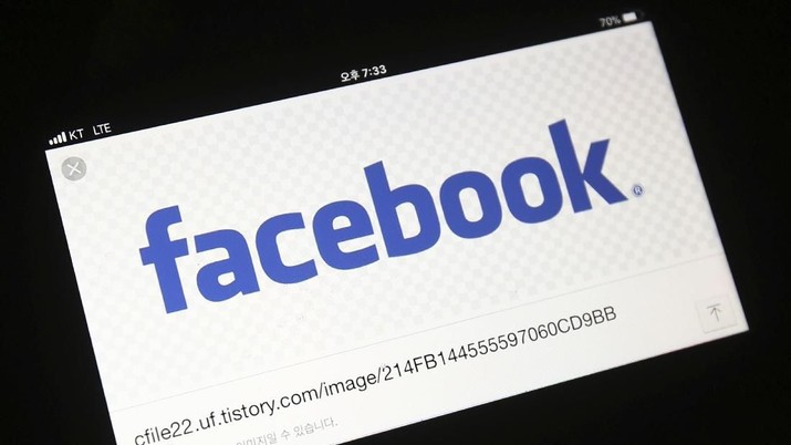 FILE - In this Wednesday, March 21, 2018 file photo, the Facebook logo is seen on a smartphone in Ilsan, South Korea. Facebook has started testing a tool that lets users move their images more easily to other online services, as it faces pressure from regulators to loosen its grip on data. The social network said Monday, Dec. 2, 2019 the new tool will allow people to transfer their photos and videos to other platforms, starting with Google Photos. (AP Photo/Ahn Young-joon)