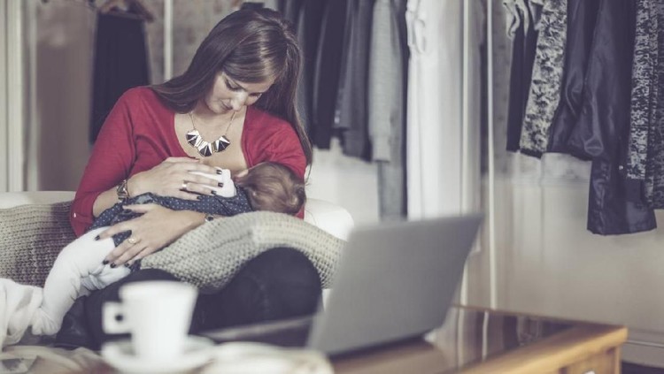 Mother breastfeeding baby son in bedroom, they enjoy in this moment together