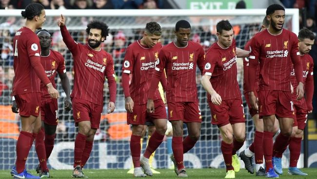 Liverpool's Mohamed Salah, 3rd left, celebrates with teammates after scoring his sides first goal during the English Premier League soccer match between Liverpool and Watford at Anfield stadium in Liverpool, England, Saturday, Dec. 14, 2019. (AP Photo/Rui Vieira)