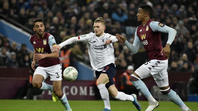 Liverpool's Harvey Elliott, center, duels for the ball with Aston Villa's Ezri Konsa, right, during the English League Cup quarter final soccer match between Aston Villa and Liverpool at Villa Park in Birmingham, England, Tuesday, Dec. 17, 2019. (AP Photo/Rui Vieira)