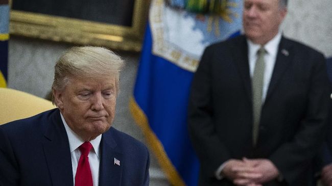 Secretary of State Mike Pompeo listens as President Donald Trump speaks during a meeting with Guatemalan President Jimmy Morales in the Oval Office of the White House, Tuesday, Dec. 17, 2019, in Washington. (AP Photo/ Evan Vucci)