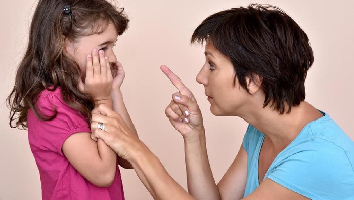 Angry mother scolding a scared daughter