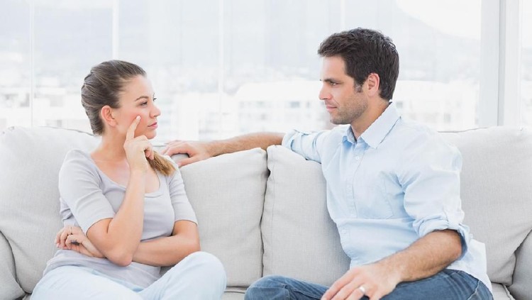 Unhappy young couple arguing standing at house door, angry husband pointing at wife blaming her of problems, conflicts in marriage, bad relationships, man and woman having quarrel or disagreement