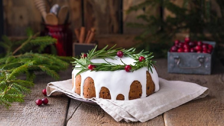 Christmas fruit cake, pudding on white plate. Copy space