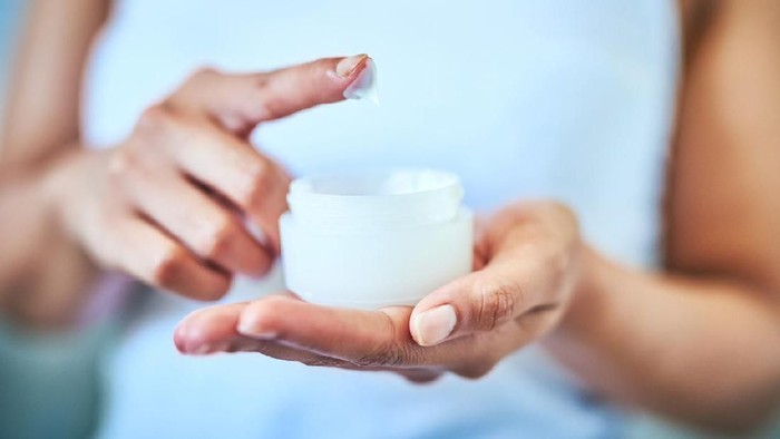 Cropped shot of an unrecognizable woman using a skincare product