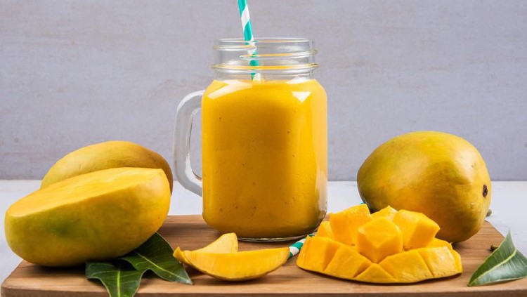 Mango Smoothie In A Bottle With Slices Of Mango Fruit