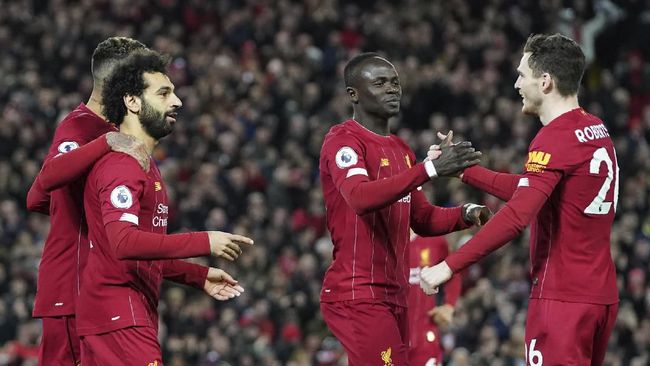 Liverpool, Sheffield United Liverpool's Mohamed Salah, front left, celebrates with teammates after scoring his side's opening goal during the English Premier League soccer match between Liverpool and Sheffield United at Anfield Stadium, Liverpool, England, Thursday, Jan. 2, 2020. (AP Photo/Jon Super)