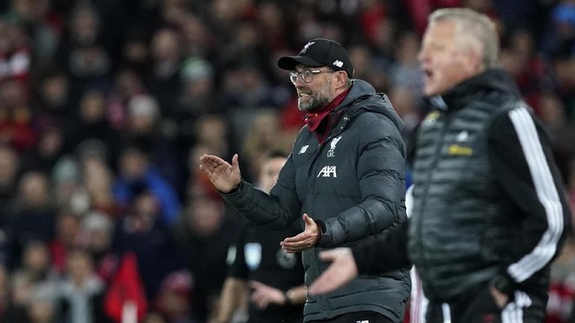 Liverpool's manager Jurgen Klopp, left, and Sheffield United's manager Chris Wilder react during the English Premier League soccer match between Liverpool and Sheffield United at Anfield Stadium, Liverpool, England, Thursday, Jan. 2, 2020. (AP Photo/Jon Super)