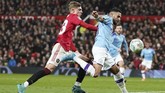 Manchester United vs Manchester City Manchester City's Riyad Mahrez, right, holds off the challenge pf Manchester United's Brandon Williams during the English League Cup semifinal first leg soccer match between Manchester United and Manchester City and at Old Trafford, Manchester, England, Tuesday, Jan. 7, 2020. (AP Photo/Jon Super)