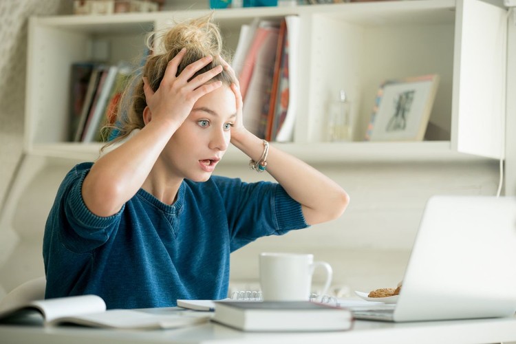 business woman feel depress and use smart phone while drinking coffee in the office
