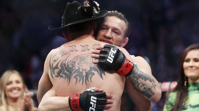 Conor McGregor, rear, embraces Donald 