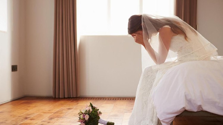 Bride In Bedroom Having Second Thoughts Before Wedding