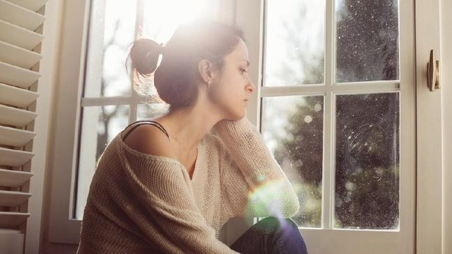 Thoughtful woman at home - copyspace