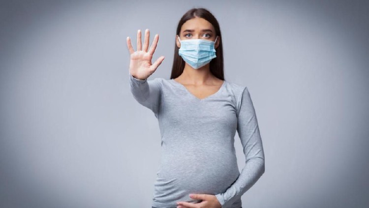 Infections In Pregnancy. Pregnant Lady In Medical Face Mask Gesturing Stop Posing Over Gray Background In Studio
