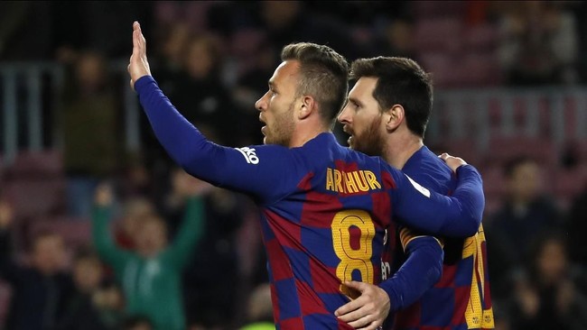 Barcelona's Arthur, left, celebrates with his teammate Lionel Messi after scoring his side's fourth goal during a Spanish Copa del Rey soccer match between Barcelona and Leganes at the Camp Nou stadium in Barcelona, Spain, Thursday, Jan. 30, 2020. (AP Photo/Joan Monfort)