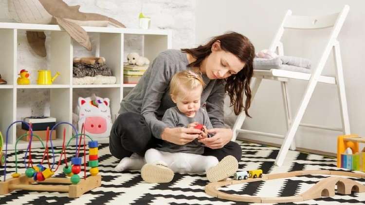 Mom and her baby girl spending time together in the nursery room