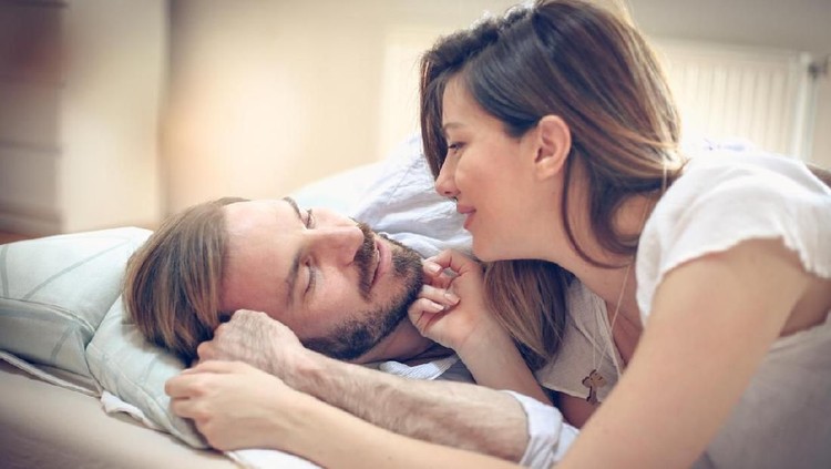 I love spending time with you. Young happy couple in bed. Space for copy. Cloe up.