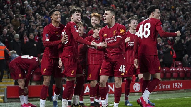 Liverpool players celebrate after Shrewsbury Town's Ro-Shaun Williams, scored an own goal during the English FA Cup Fourth Round replay soccer match between Liverpool and Shrewsbury Town at Anfield Stadium, Liverpool, England, Tuesday, Feb. 4, 2020. (AP Photo/Jon Super)