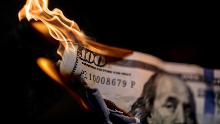 A stock photo of 100 dollars on fire. Please note the money is not real and is marked 